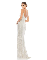 This elegant Mac Duggal, long, silver All over-sequined sleeveless gown with a plunging sweetheart neckline, a low scoop back, and a floor-length skirt featuring a high front slit and delicate sweeping train. This elegant evening dress is the perfect dress perfect for proms, black-tie affairs, weddings and special events! back