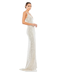 This elegant Mac Duggal, long, silver All over-sequined sleeveless gown with a plunging sweetheart neckline, a low scoop back, and a floor-length skirt featuring a high front slit and delicate sweeping train. This elegant evening dress is the perfect dress perfect for proms, black-tie affairs, weddings and special events! side