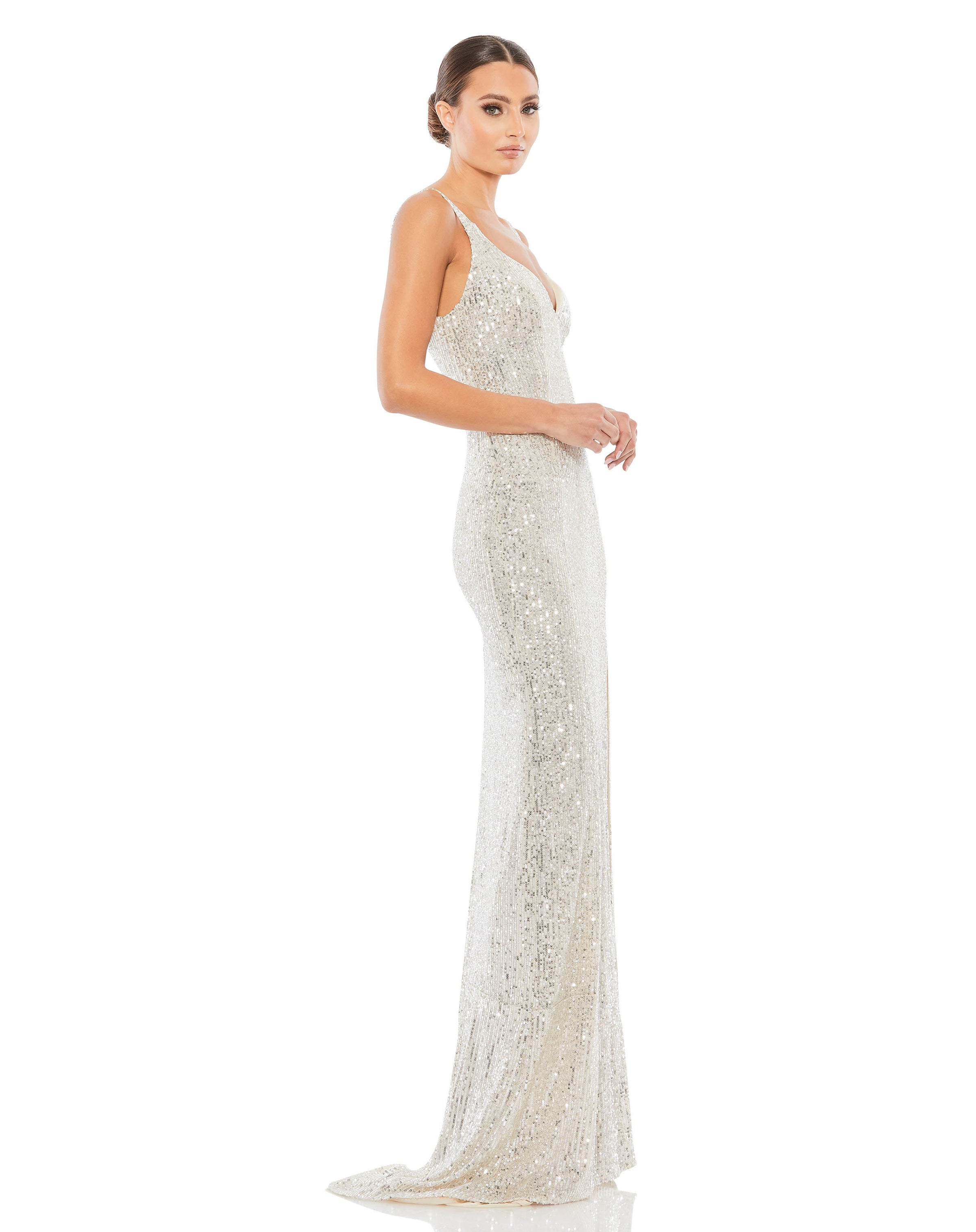 This elegant Mac Duggal, long, silver All over-sequined sleeveless gown with a plunging sweetheart neckline, a low scoop back, and a floor-length skirt featuring a high front slit and delicate sweeping train. This elegant evening dress is the perfect dress perfect for proms, black-tie affairs, weddings and special events! side
