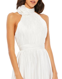 This elegant white floor length, halterneck, sleeveless evening gown is perfect for brides and brides to be! Crafted with delicate chiffon, this dress features a ruched bodice and waistband, together with an open back, and a rosette neckline. The flowing  floor-length skirt features a thigh-high slit for a dramatic finish close up