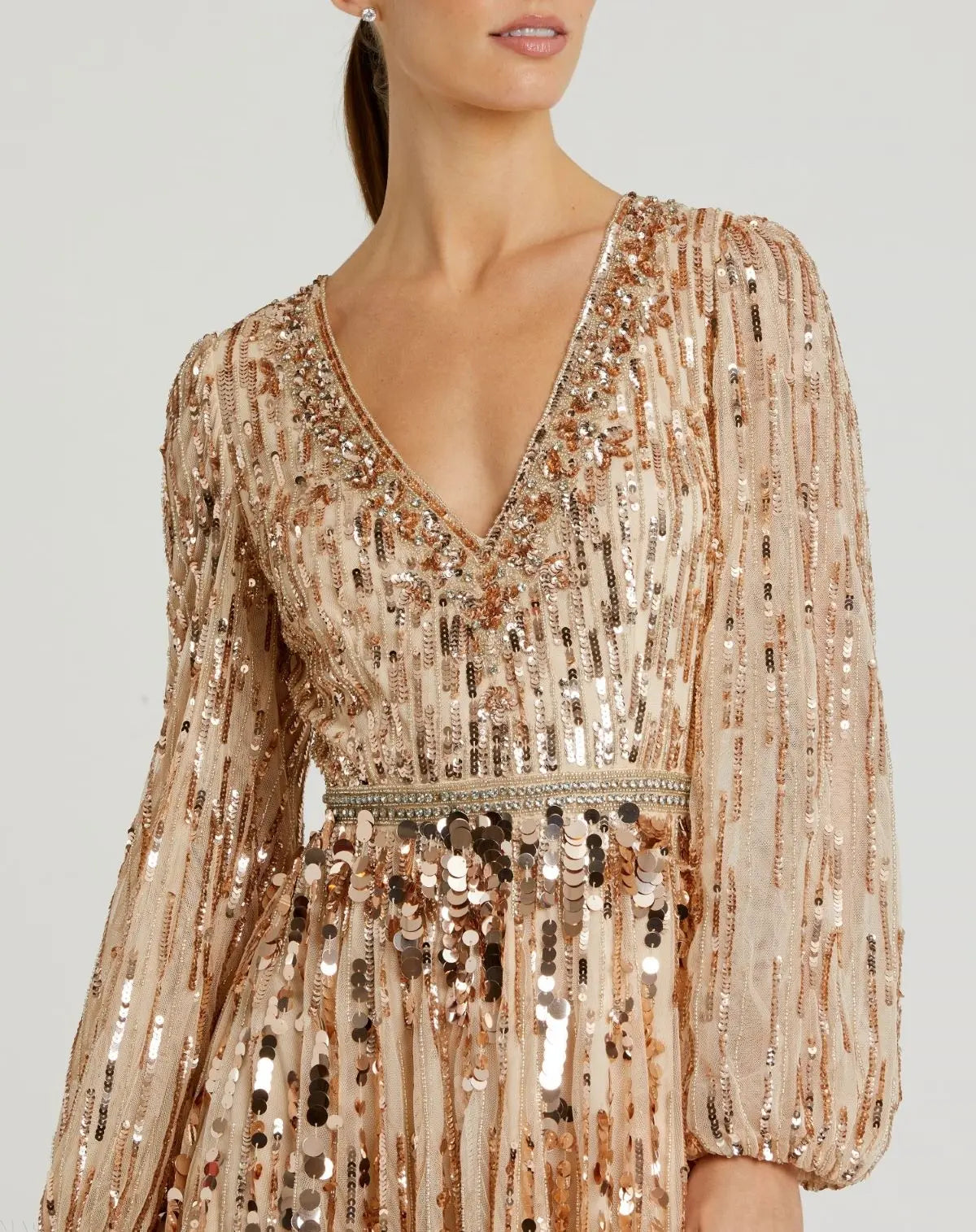 Detailed-view-of-shimmering-sequins-and-beaded-waistband-on-bisque-gown