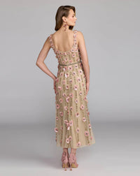 Woman wearing a floral dress with a plain background
