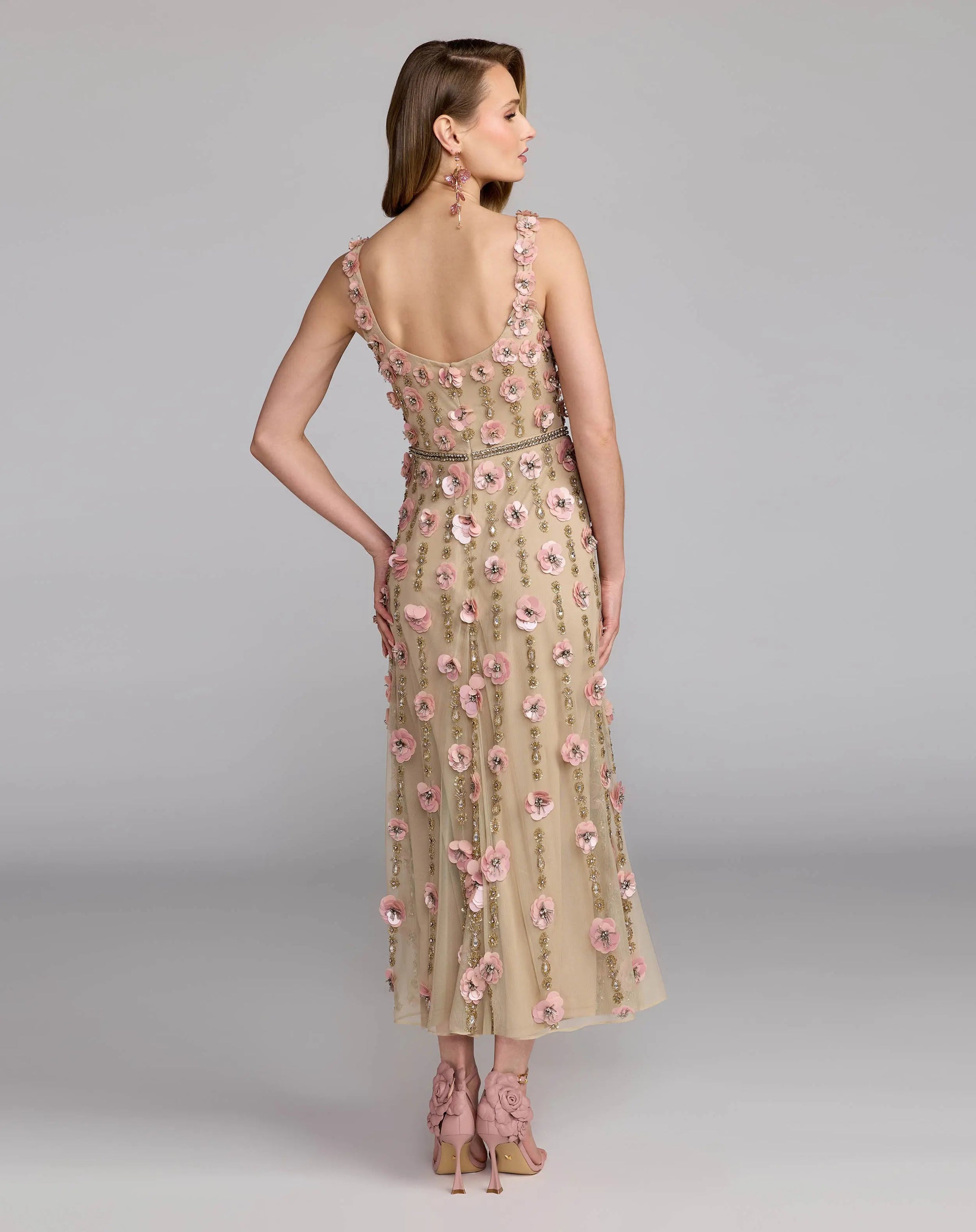 Woman wearing a floral dress with a plain background