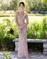 Woman in a sparkling evening gown standing in a garden setting