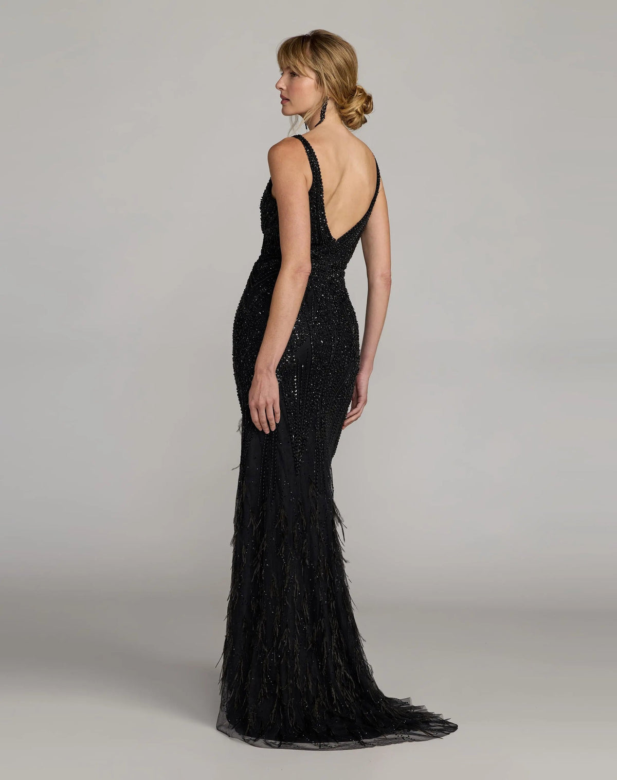 Back-view-of-beaded-black-gown-showcasing-v-back-and-sweeping-train