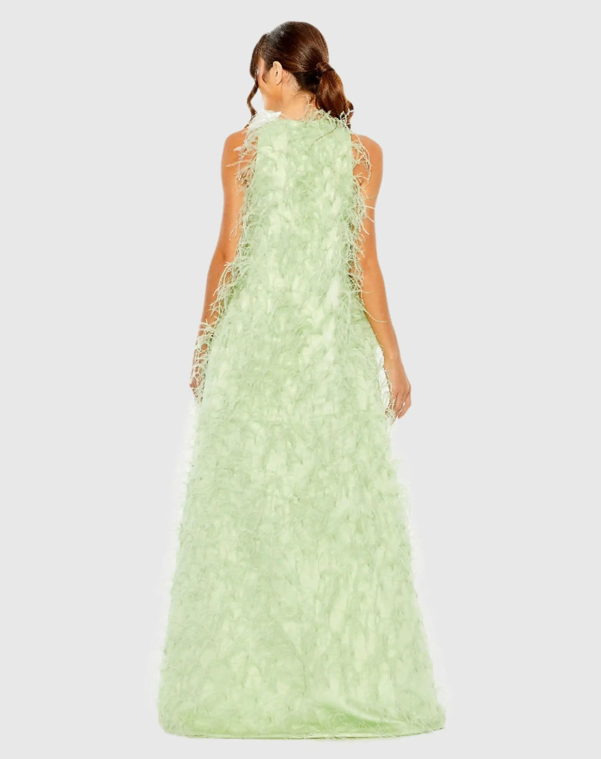 Back view of the Mint formal dress highlighting the continuous feather design, clean zip closure, and floor-sweeping back hem.