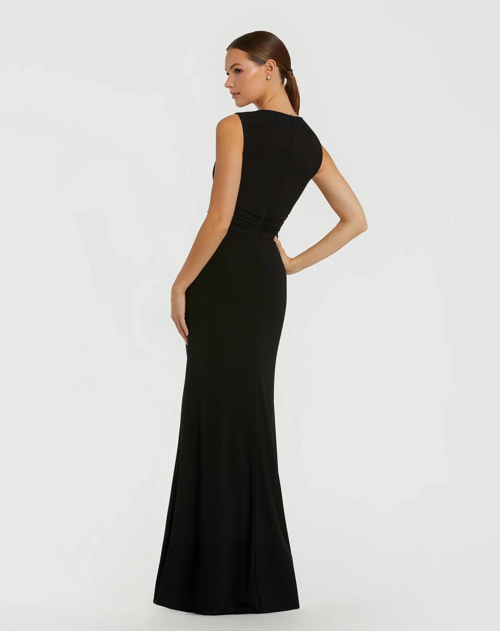 Woman wearing a black evening gown on a white background