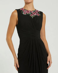 Black dress with floral embroidery on a white background