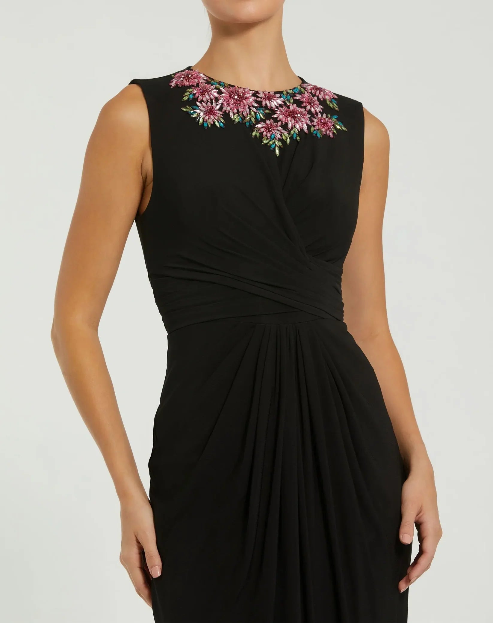 Black dress with floral embroidery on a white background