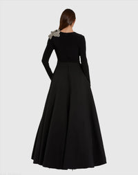 Black evening gown with floral detail on a white background