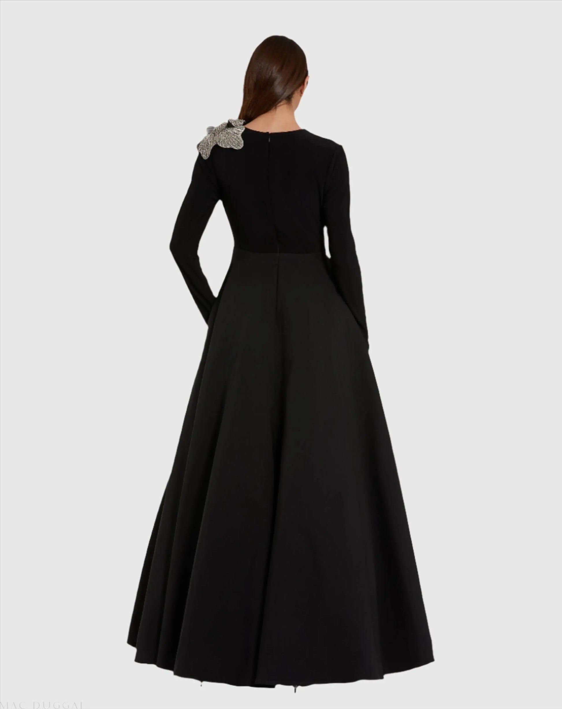 Black evening gown with floral detail on a white background