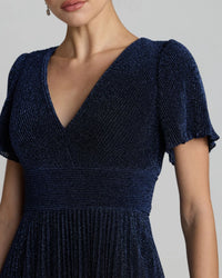 Navy blue dress with short sleeves on a neutral background
