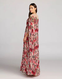 Rear view of the floral chiffon gown showing the dramatic cape movement and button back closure.