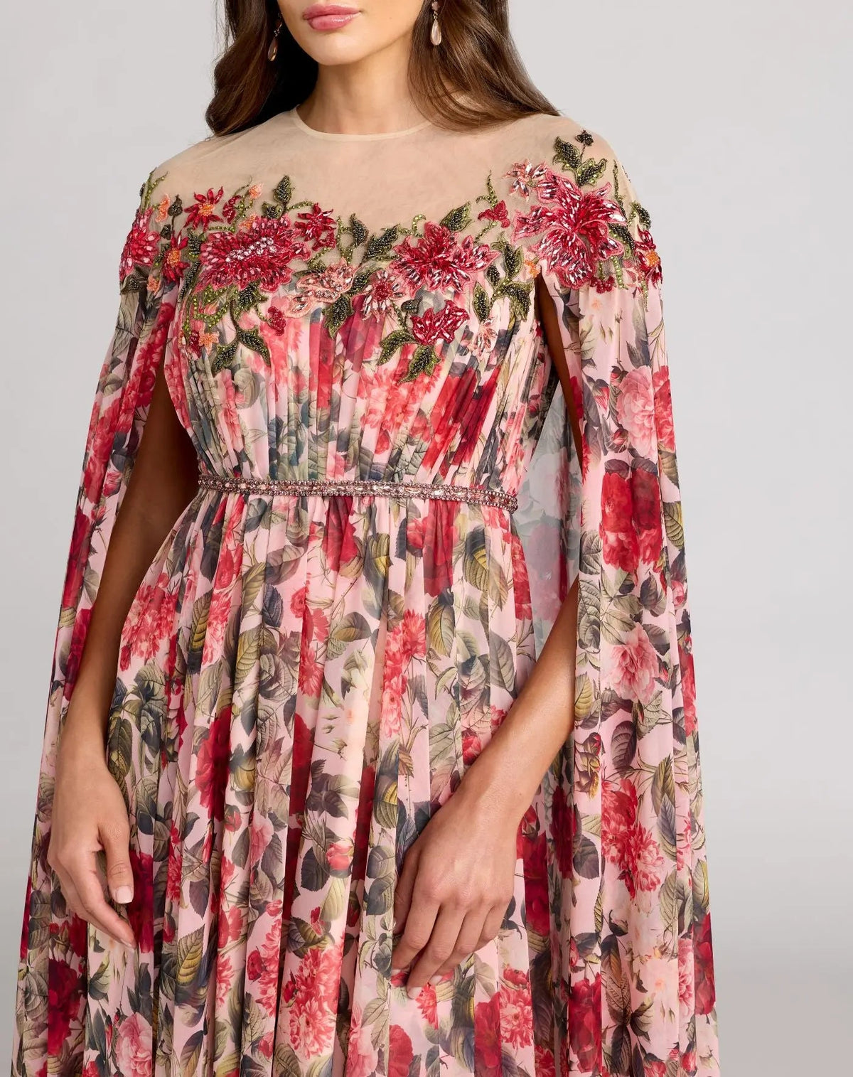 Close-up front view of the pleated bodice, floral embroidery, and rhinestone-embellished waistband.