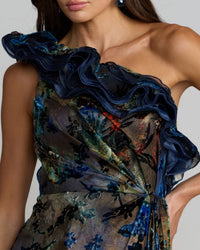 Close-up of a floral one-shoulder dress with ruffled details.