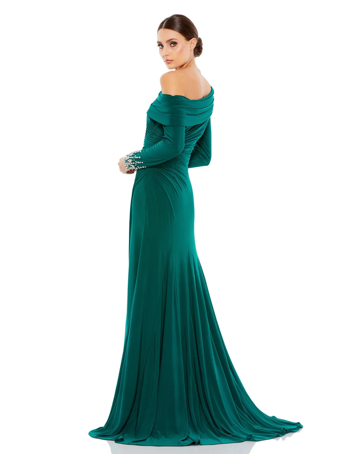 This stunningly elegant, floor-length, emerald green Mac Duggal, evening dress is a long sleeve jersey gown accented with jewelled cuffs and finished with a thigh-high slit! This bodycon, form-fitting evening gown is perfect for proms, black-tie affairs, weddings and special events back view