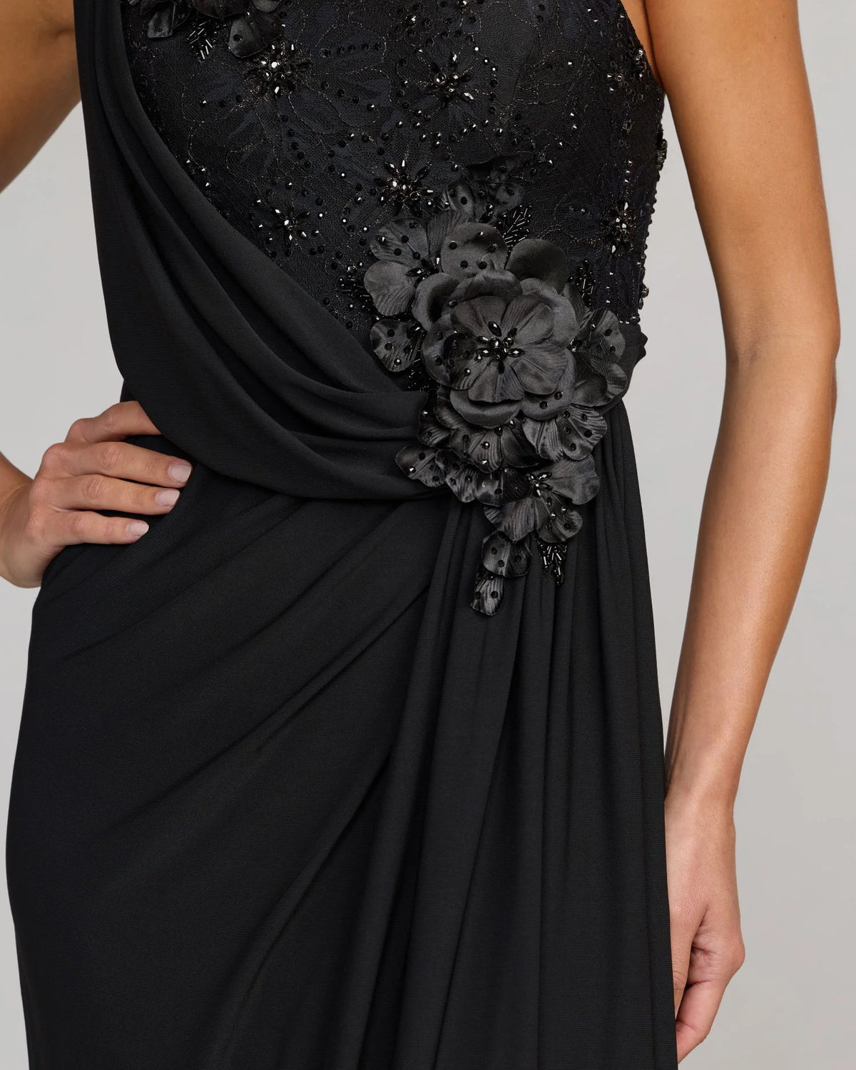 Close up of model in Black asymmetric, grecian style, gown, style 13210, 