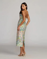 Woman wearing a floral dress on a gray background
