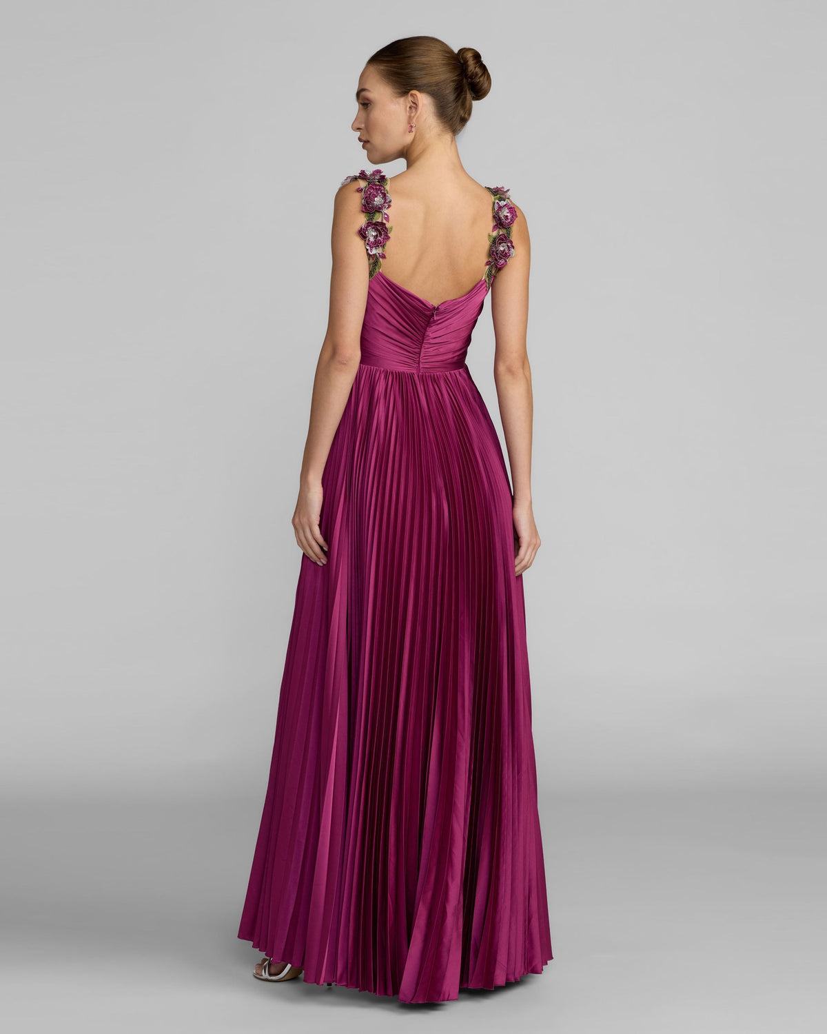 Back view of the magenta satin gown, showing the bodice, zipper, and flowing high-low skirt.
