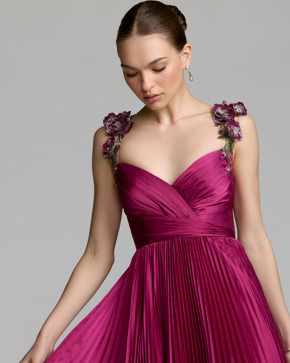Detailed close-up of the floral embroidered spaghetti strap and bodice construction.