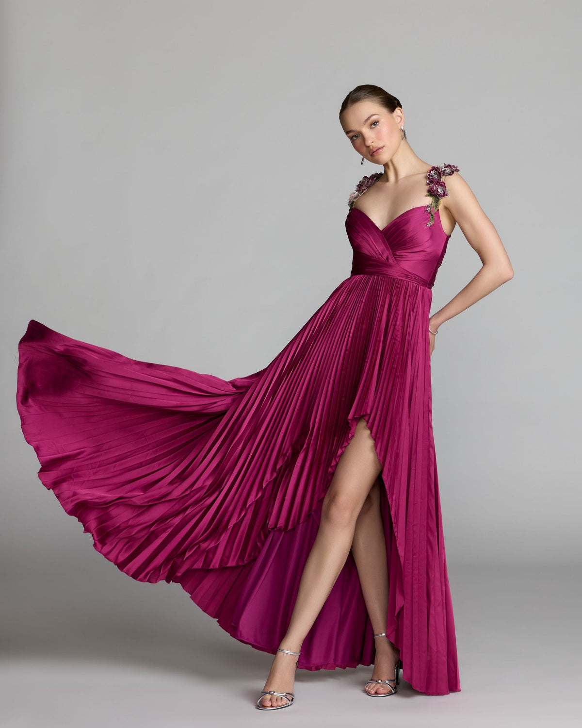 Full-length front studio view of the magenta high-low gown with floral straps.