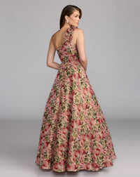 Woman wearing a floral evening gown against a gray background