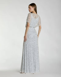 Back view of the Powder Blue formal dress highlighting the dramatic, sheer cape overlay, clean column fit, and hidden zipper closure.