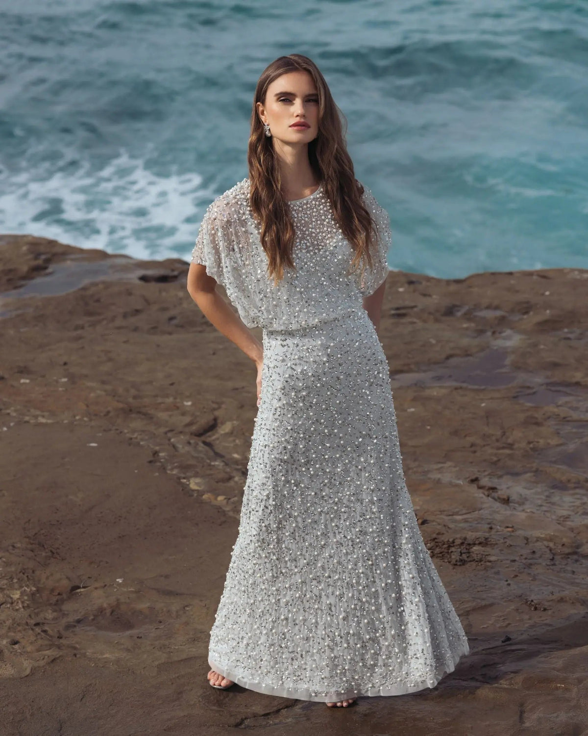 Additional outdoor lifestyle angle highlighting the soft pastel hue and luxurious texture of the allover pearl embellishments.