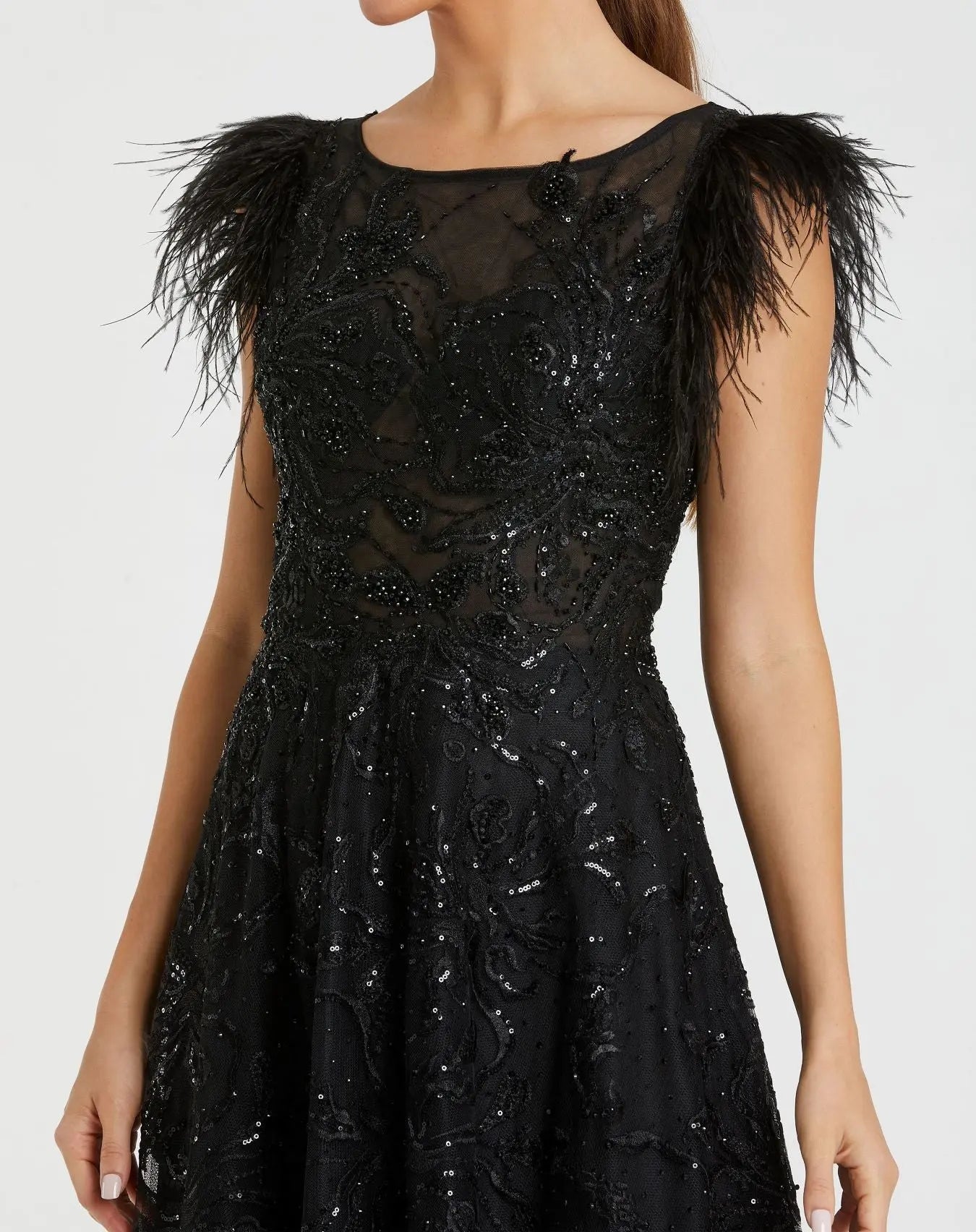 Black dress with feathered shoulders on a white background