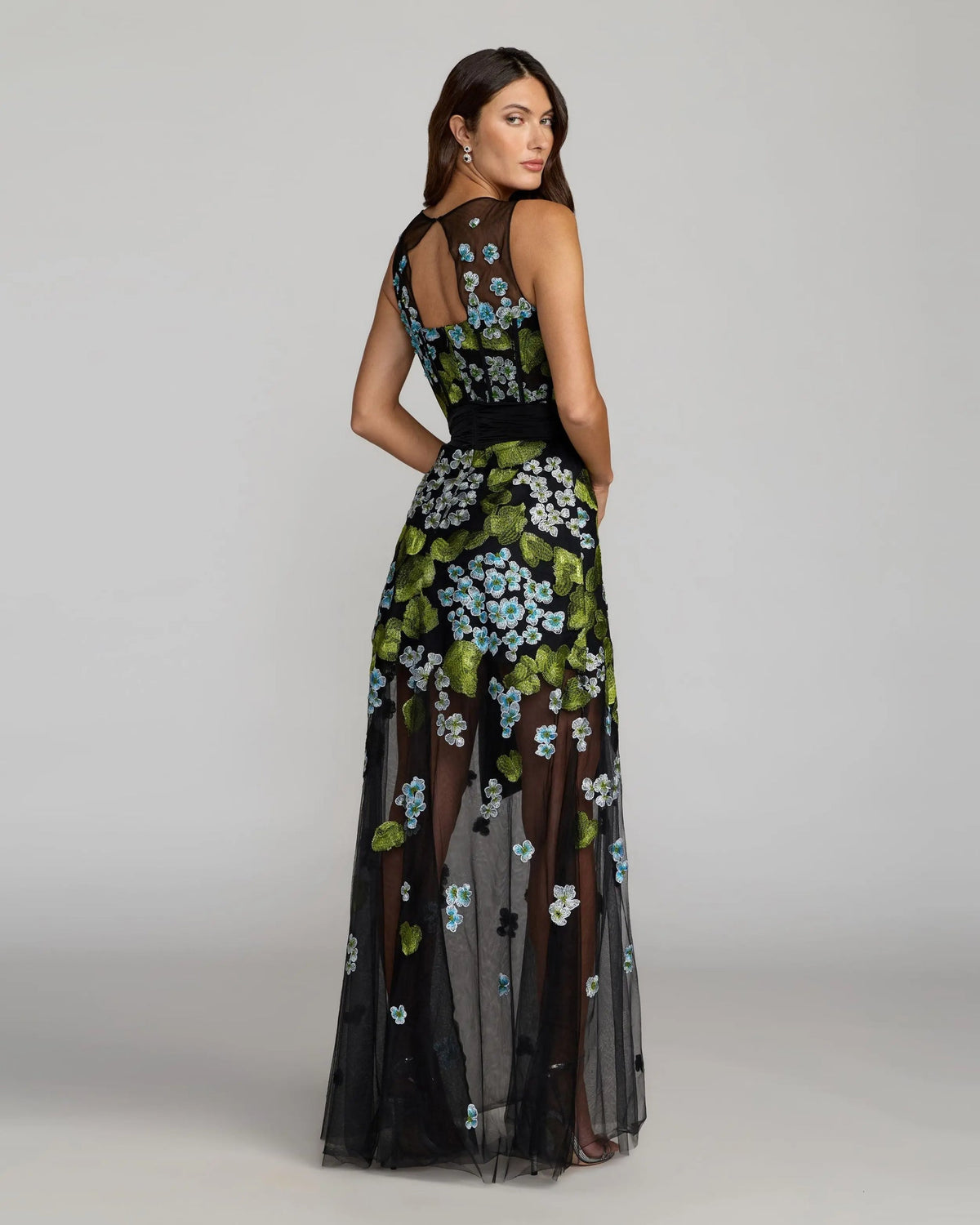 Side view of model wearing Mac Duggal Black Floral Embroidered Corset Gown With Bow #21058 Blue Multi