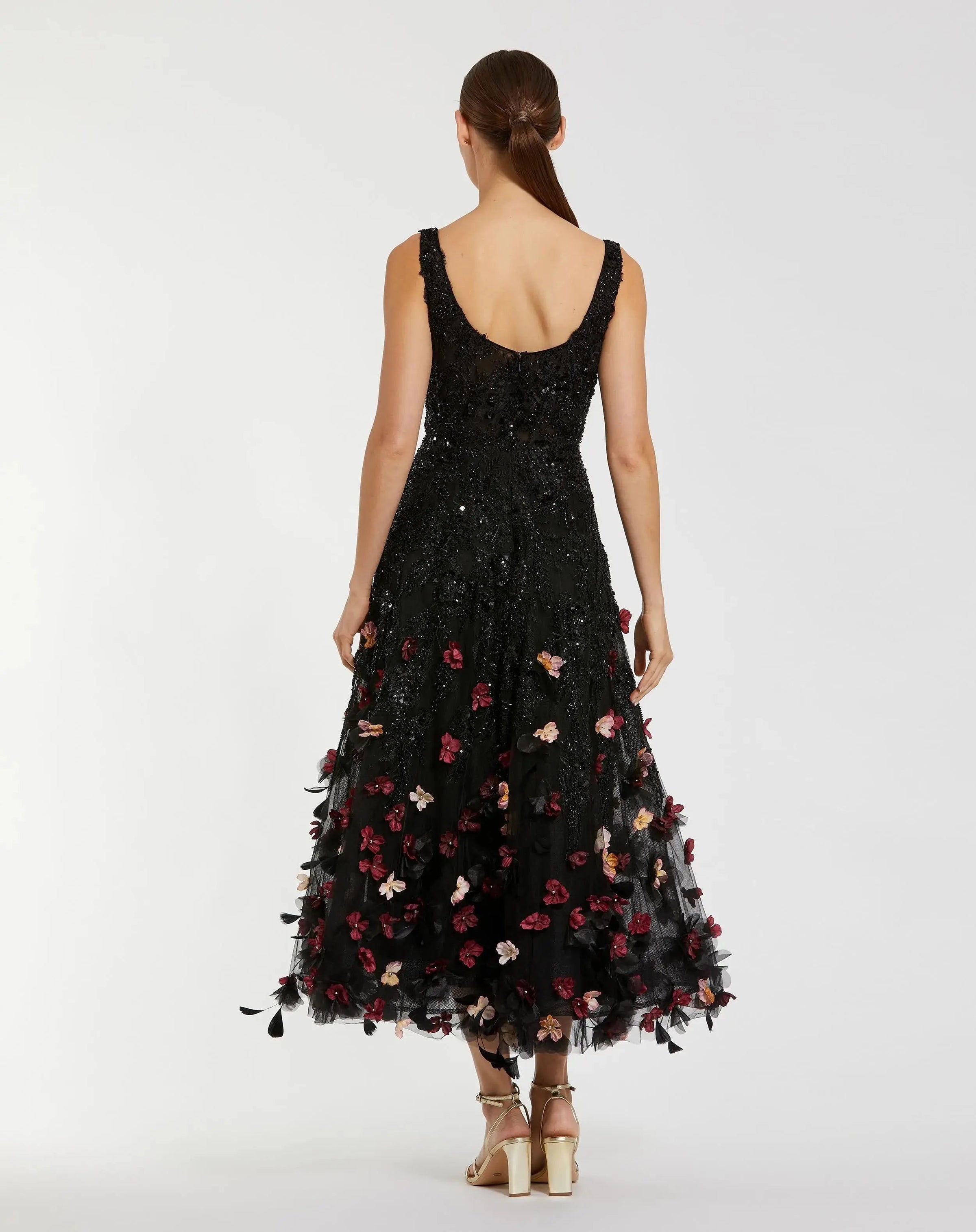 Black dress with floral embroidery on a white background