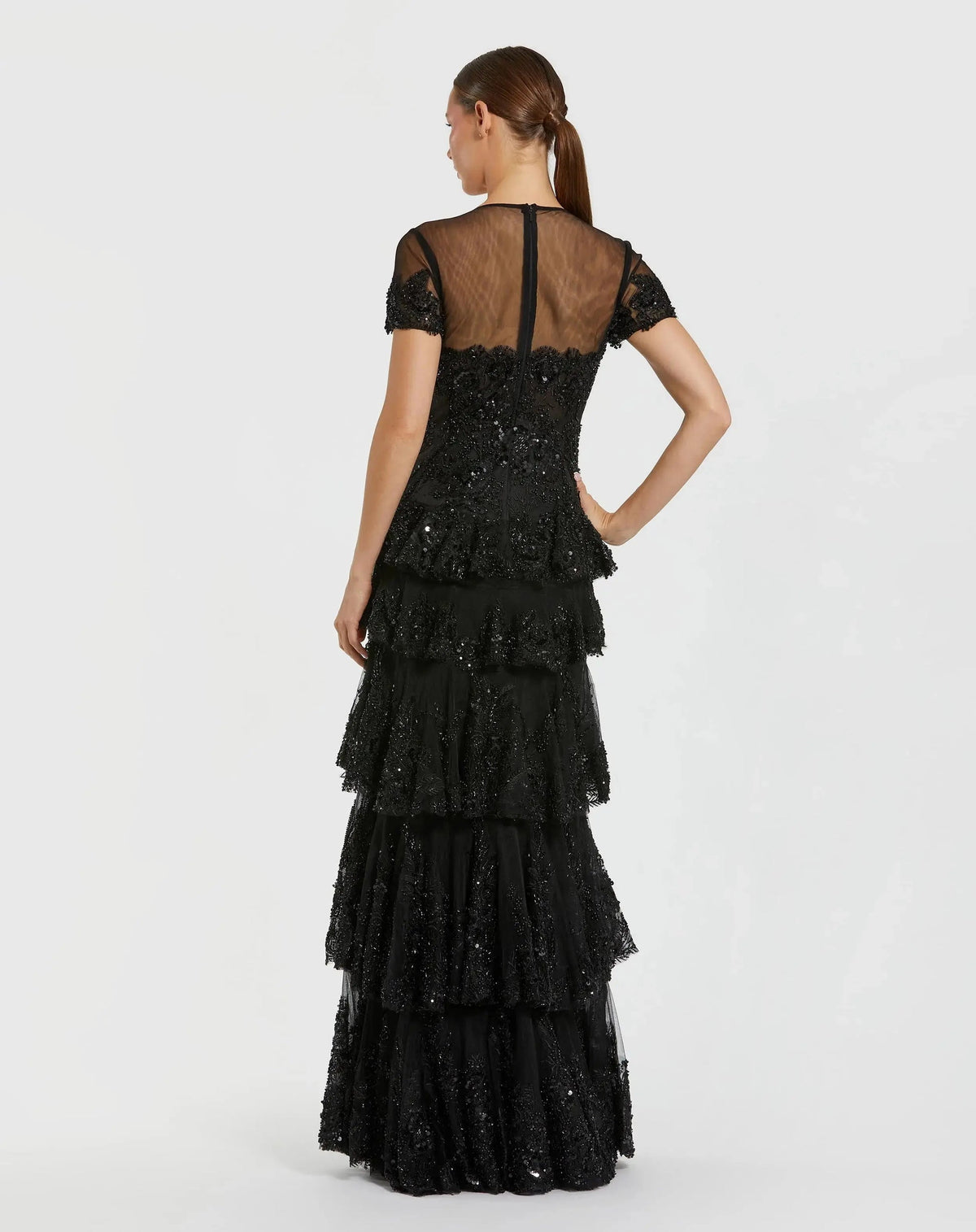 Lifestyle-studio-shot-of-model-wearing-black-tiered-ruffle-formal-gown