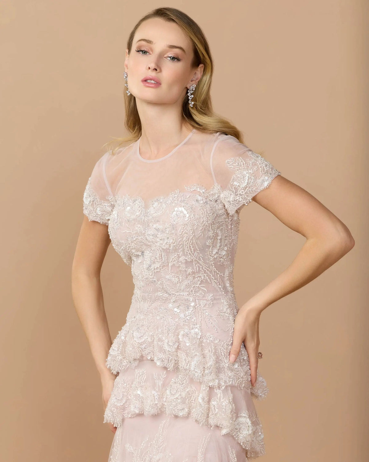Lifestyle-studio-shot-of-model-wearing-rose-multi-tiered-ruffle-gown
