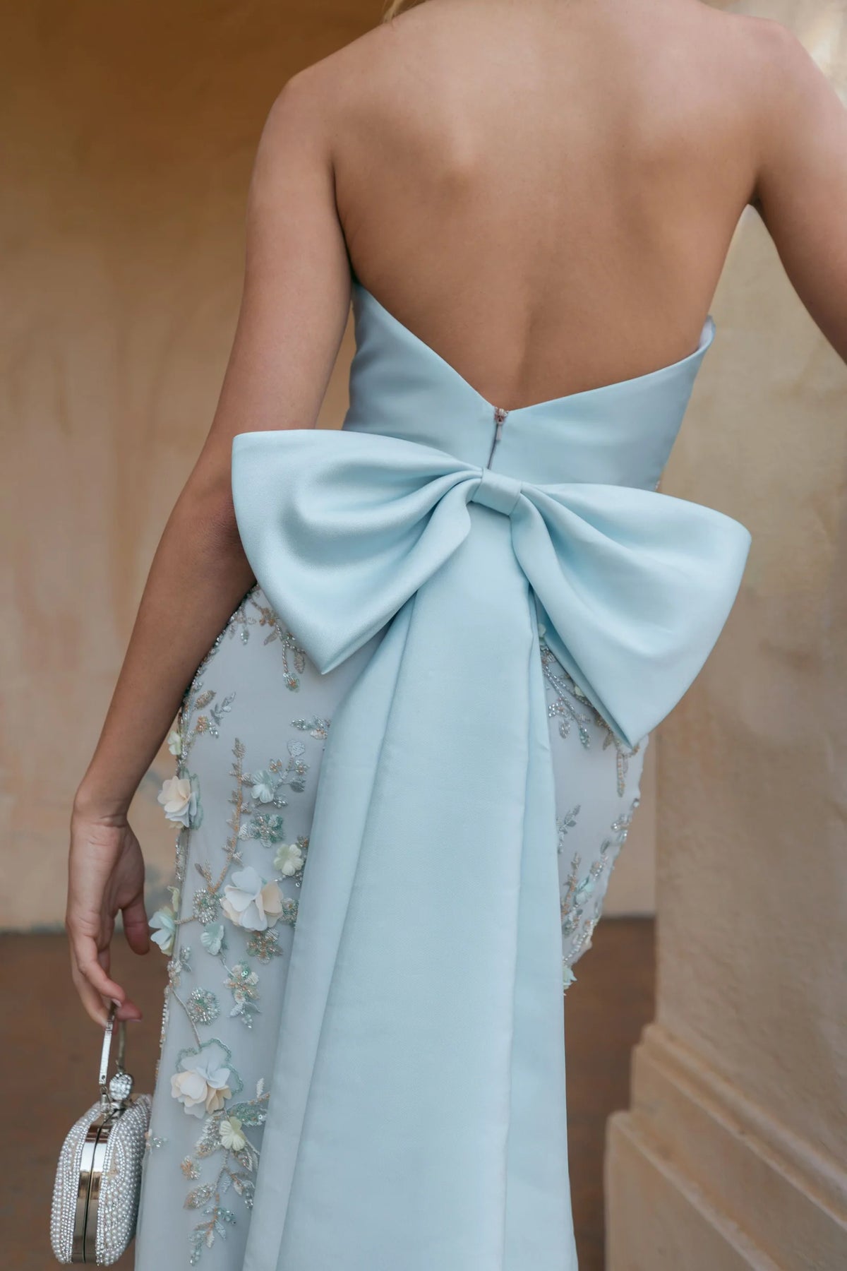 Blue strapless satin mermaid gown with bow details