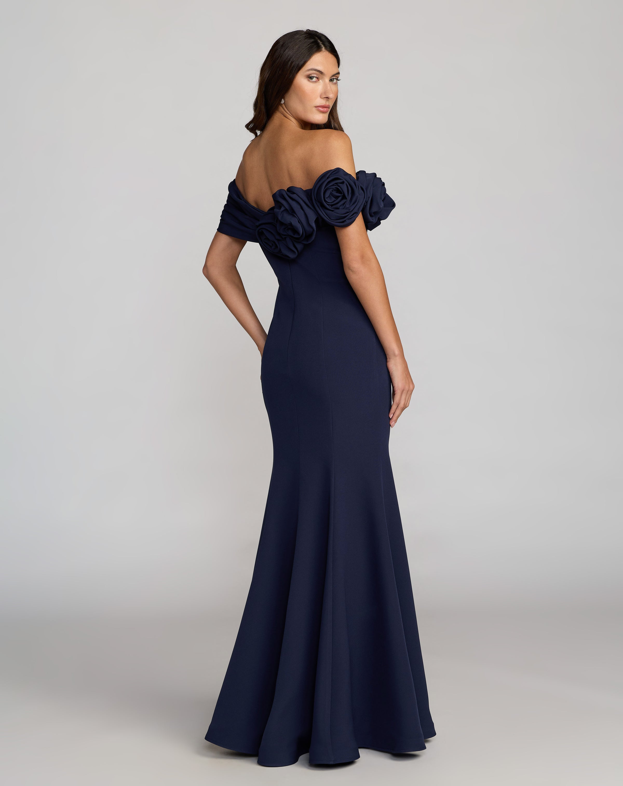Side view of model wearing Navy Off The Shoulder Rosette Crepe Mermaid Gown