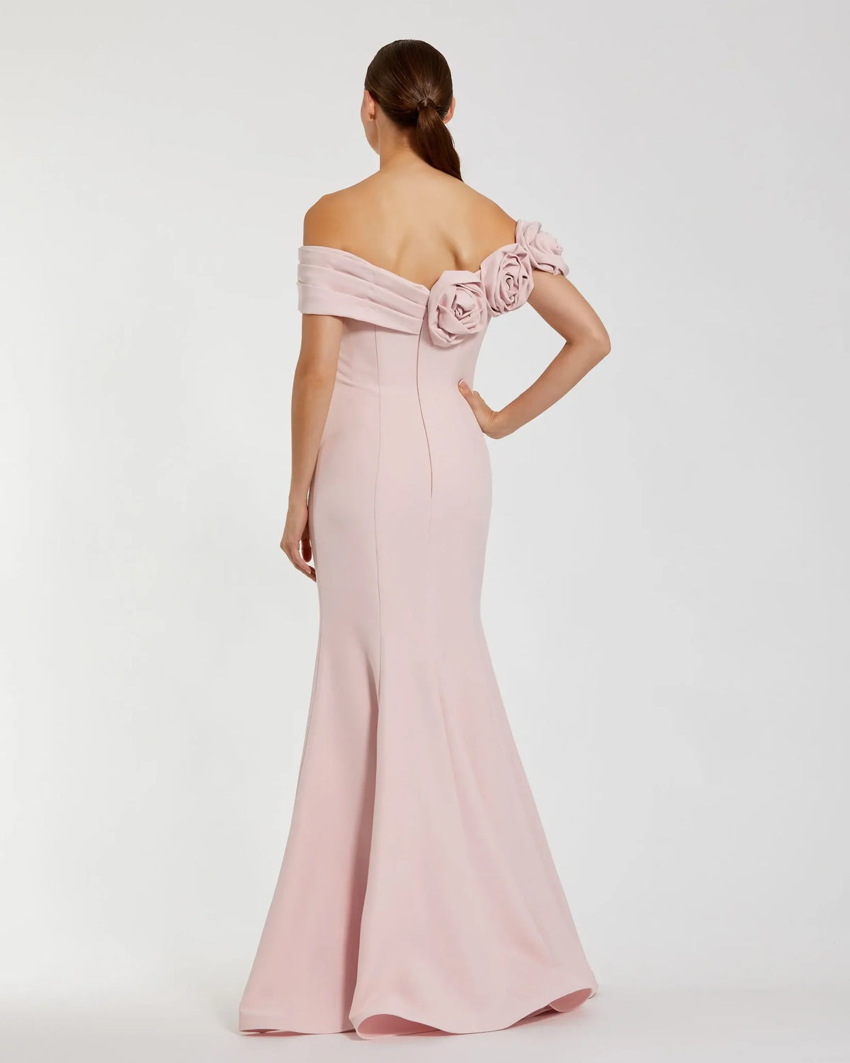 Pink off-shoulder gown with floral details on a white background