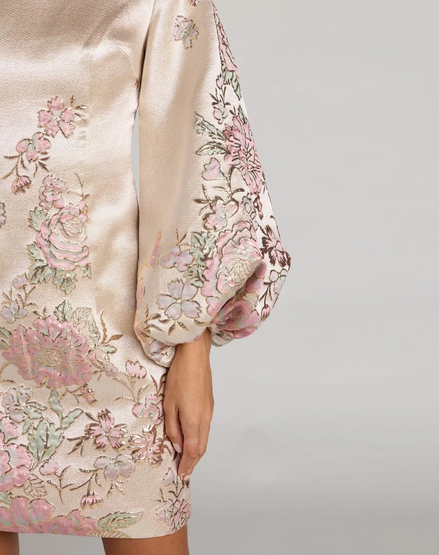 Beige dress with floral embroidery on a plain background
