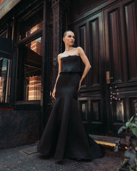 Mac Duggal #21270 black satin corset peplum gown lifestyle shot