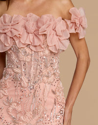Close-up view of the off-the-shoulder neckline with 3D organza flowers on the blush embellished lace gown.