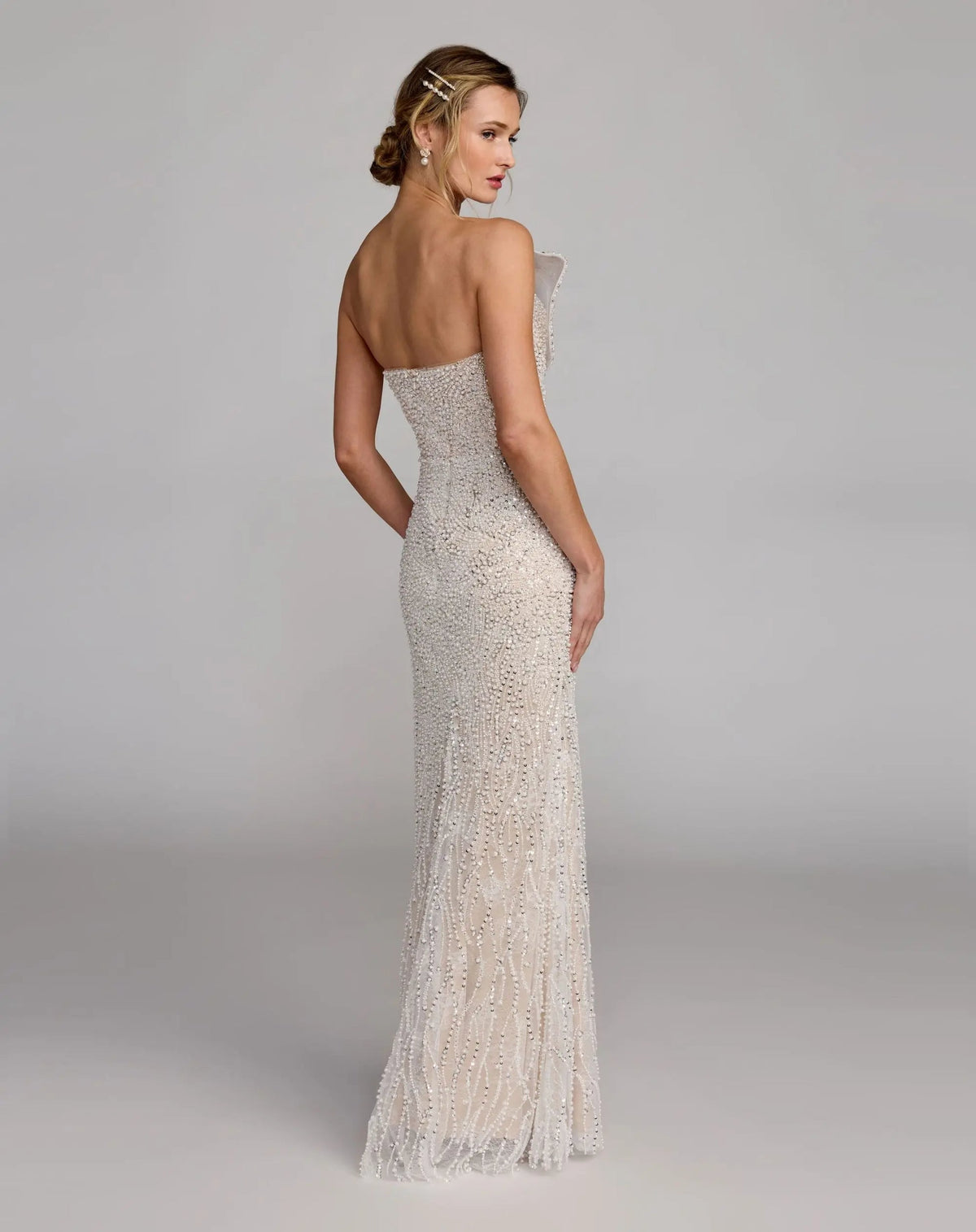 Back view of the Ivory Nude formal dress highlighting the continuous sequin pattern, sleek fit, and concealed back zipper.