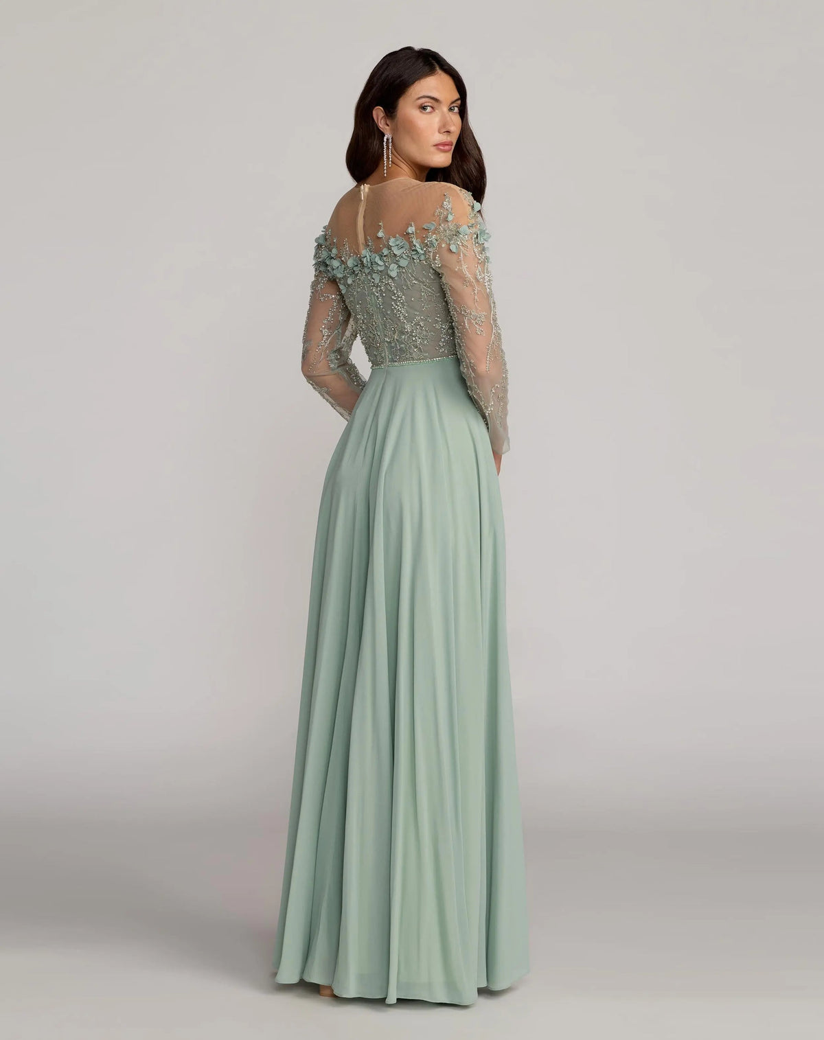 side view of model wearing Mac Duggal Style 21315 Sage green tulle gown with floral appliqué and A-line silhouette