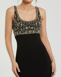 Black dress with a gold sequin top on a white background