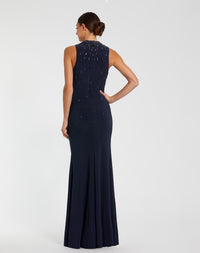 Navy evening gown with beaded detailing on a white background