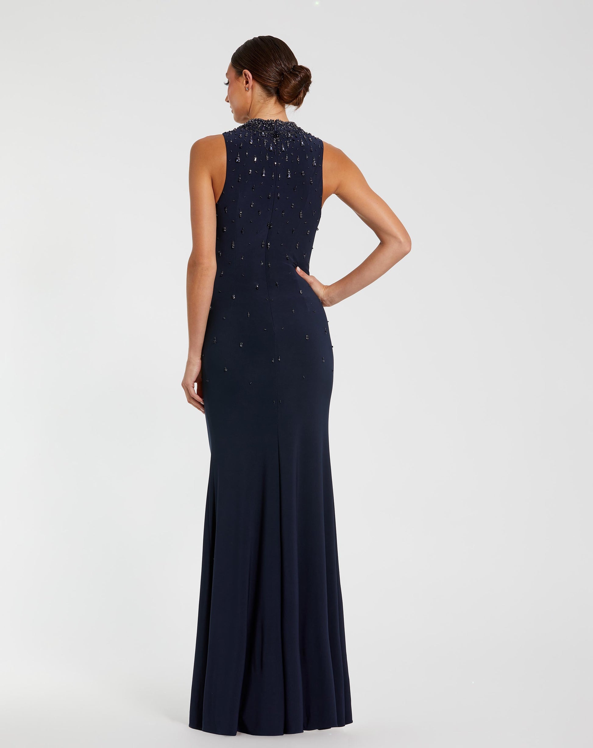 Navy evening gown with beaded detailing on a white background