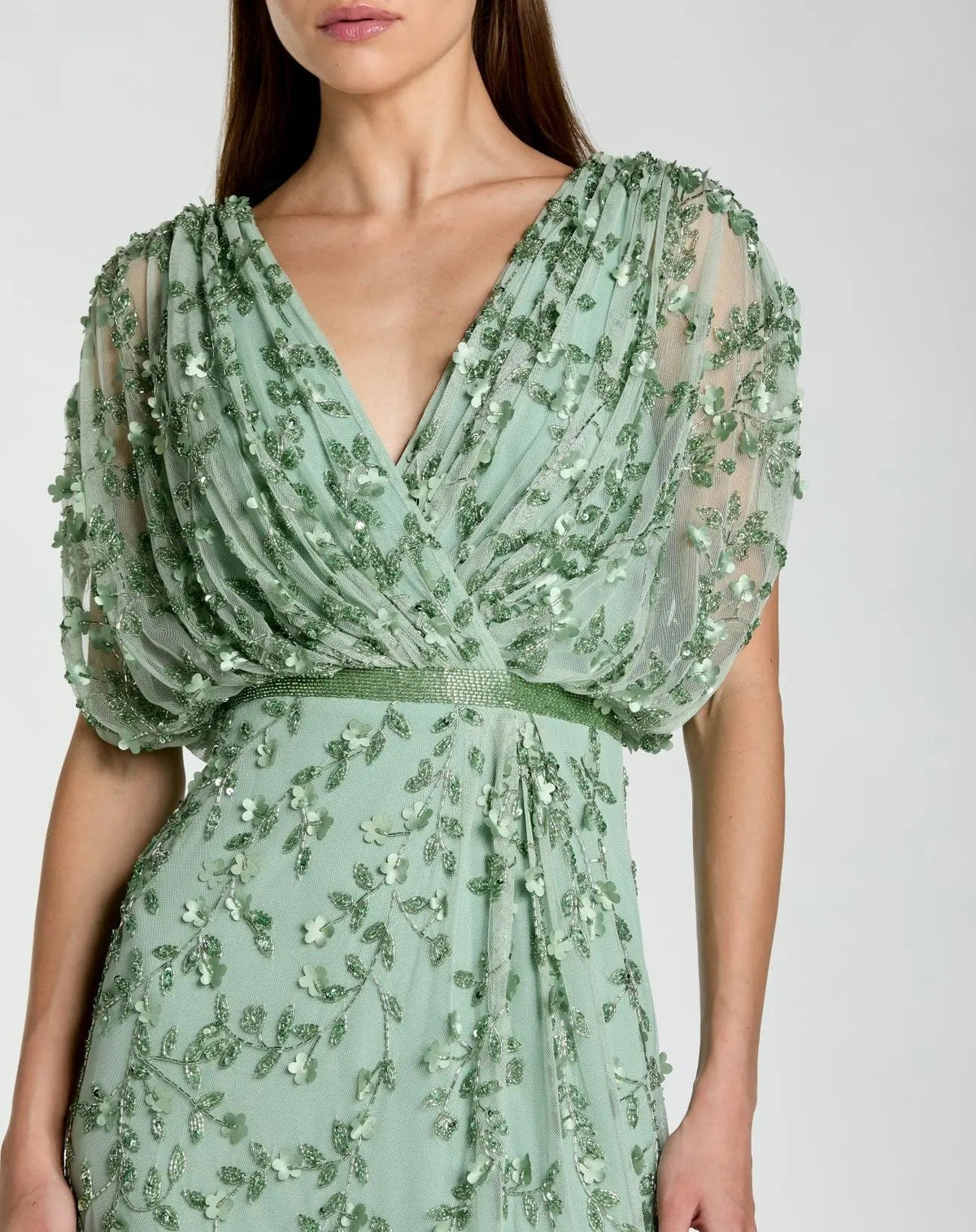 Close-up detail of the V-neckline, blouson bodice, and intricate empire waist beading on the Seafoam gown.