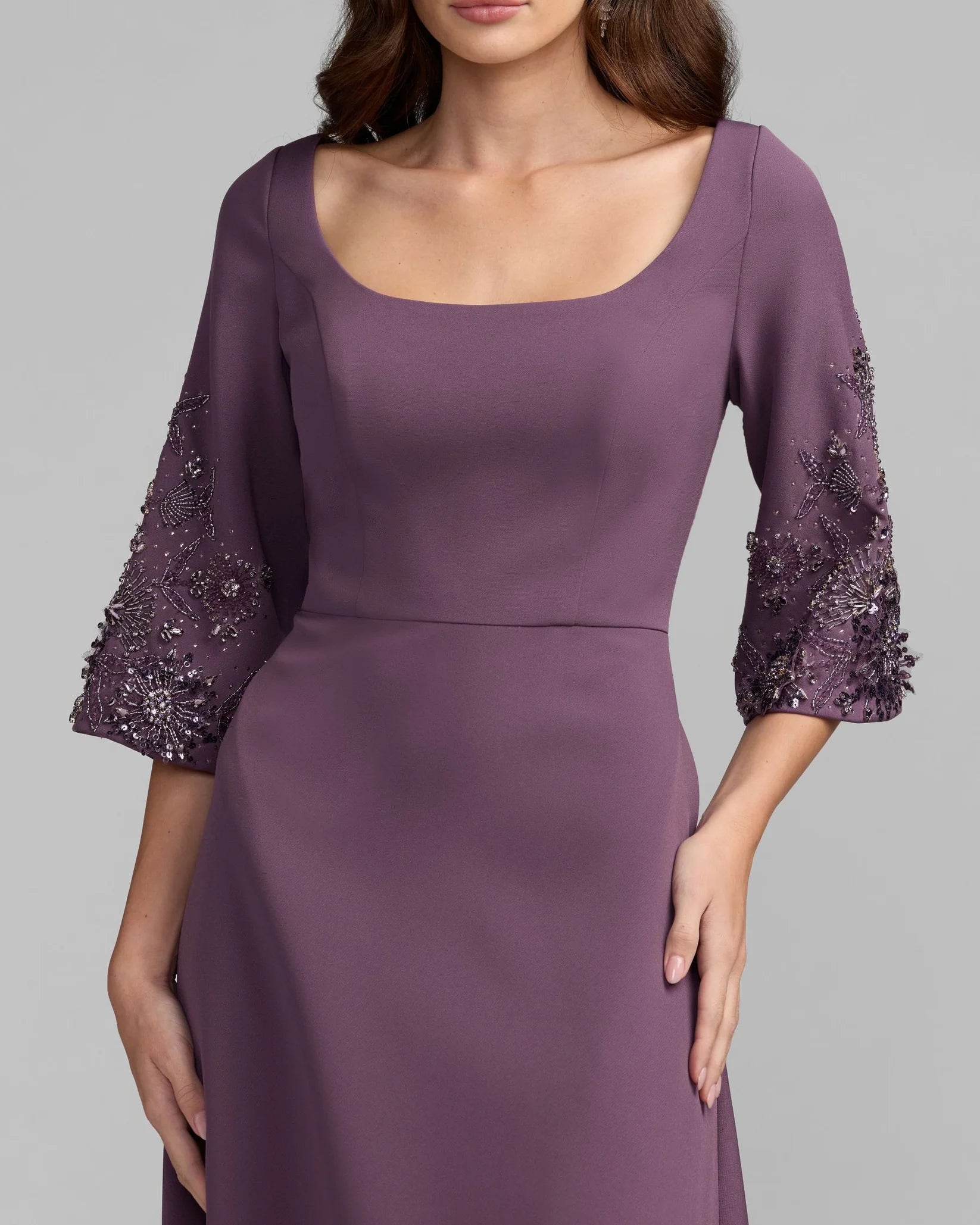 Purple dress with embellished sleeves on a gray background