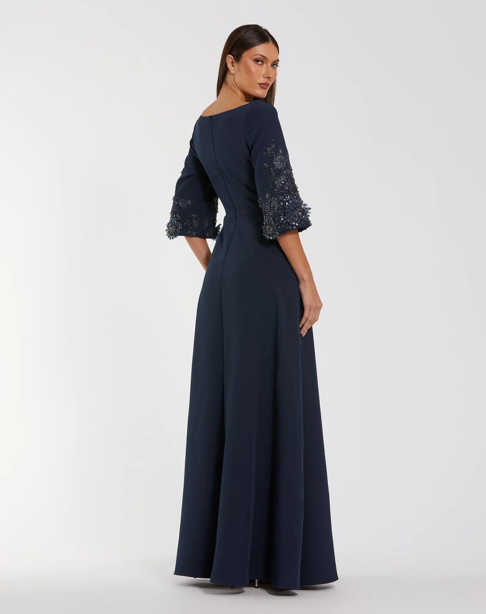 Navy blue evening gown with lace sleeves on a white background
