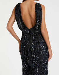 Black sequin dress with open back on a white background