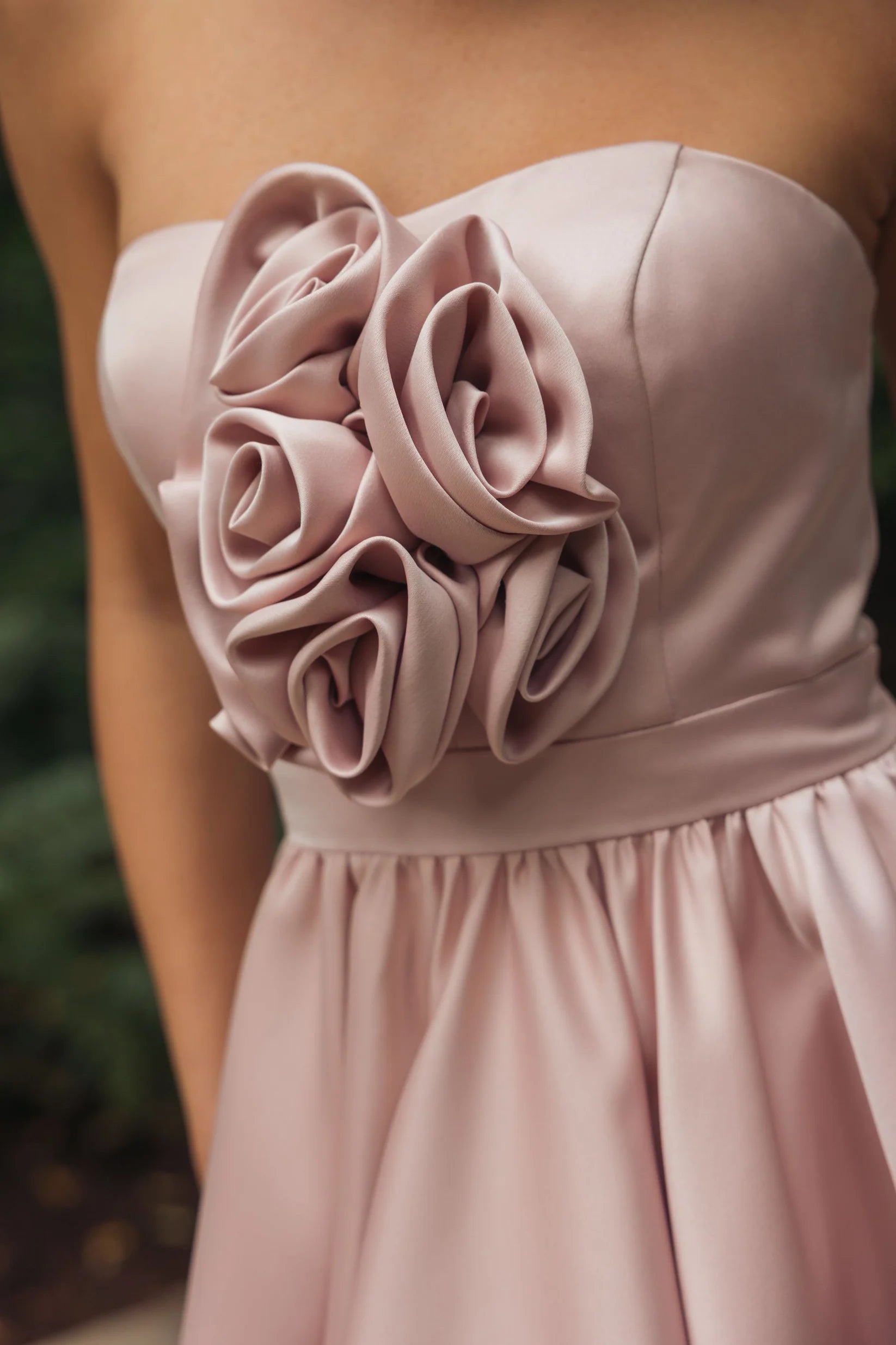 Blush strapless satin high-low gown with rosette