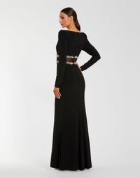 Black evening gown with long sleeves and embellishments on a white background